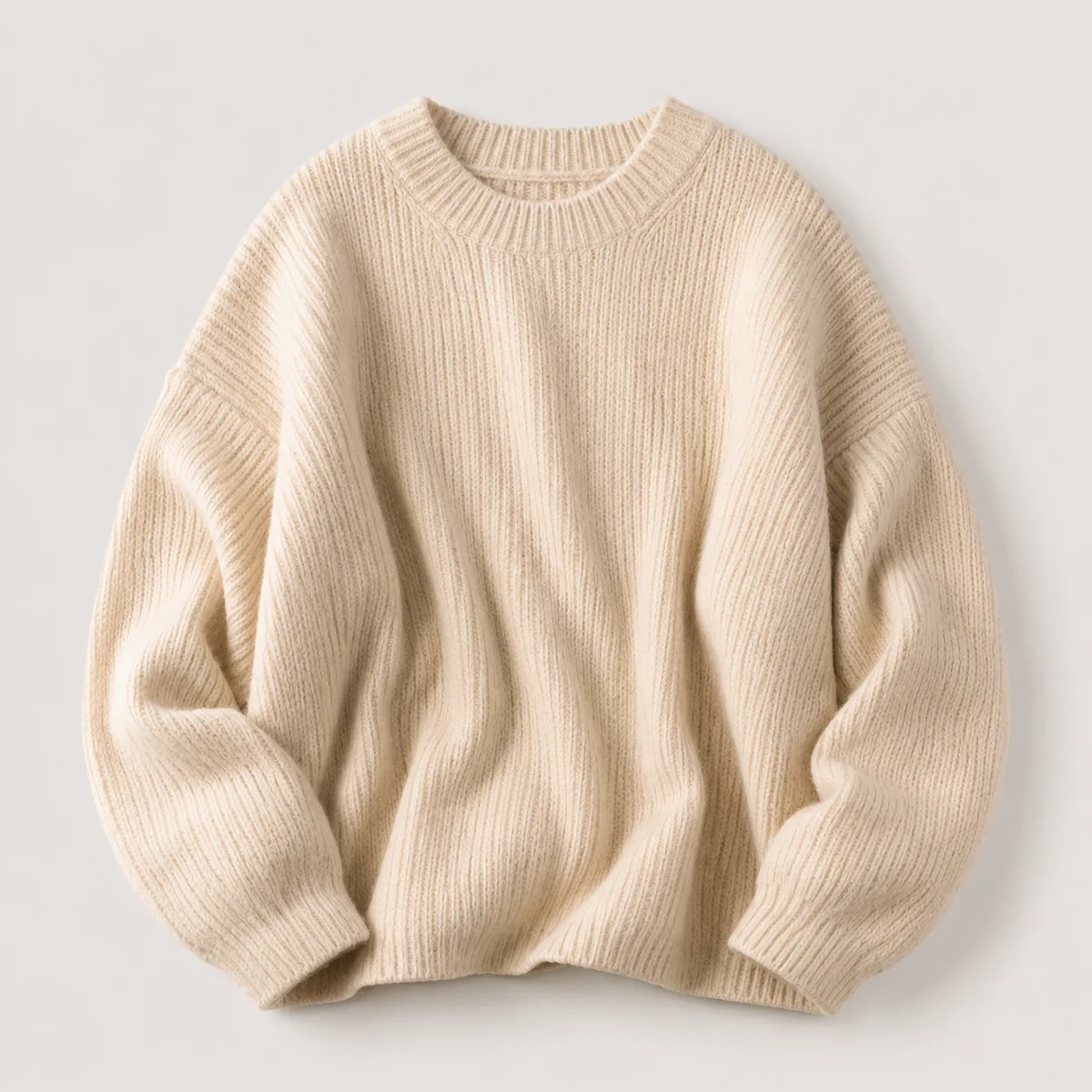 Cream oversized knit sweater on a plain background